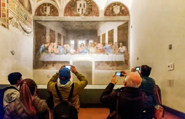 Visitors photographing Leonardo&rsquo;s Last Supper in the refectory