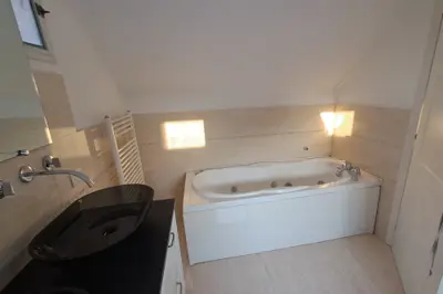 The hot tub in the main bathroom